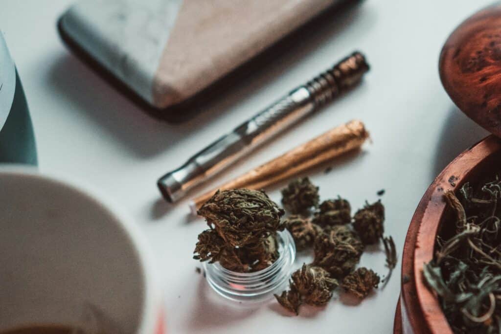 Frost Nova cannabis buds with testing tools on a white surface.
