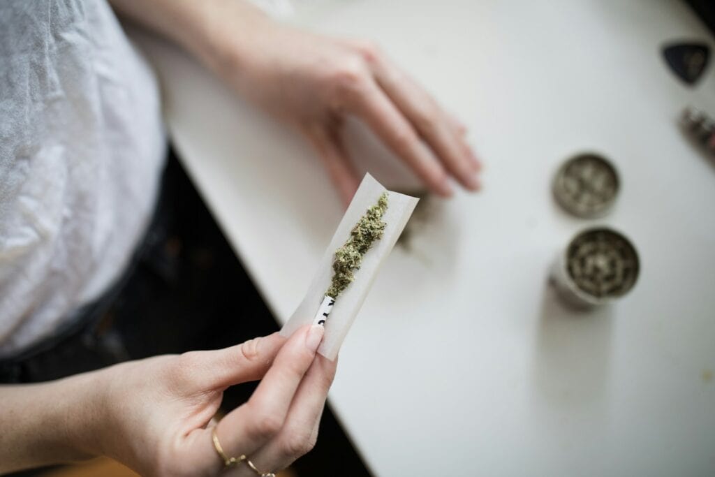 Cannabis strain Dulce de Fresa being rolled for consumption.